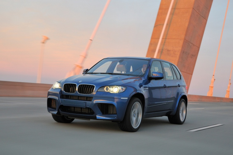 Driving 2013 BMW X5 M in Monte Carlo Blue Metallic from a front left three-quarter view